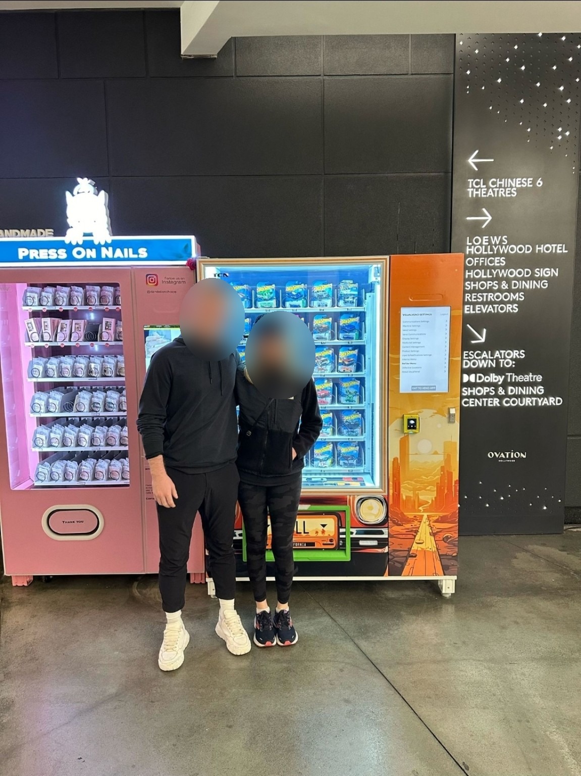 Client beside the finished Vending Blue machine, with faces blurred